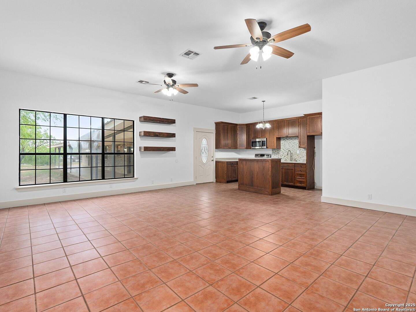 601 Wild Flower Drive Lytle, TX 78052 - Photo 37 of 50 a view of a kitchen with furniture a ceiling fan and window