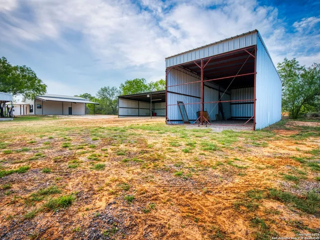 a view of a house with a swimming pool and sitting area