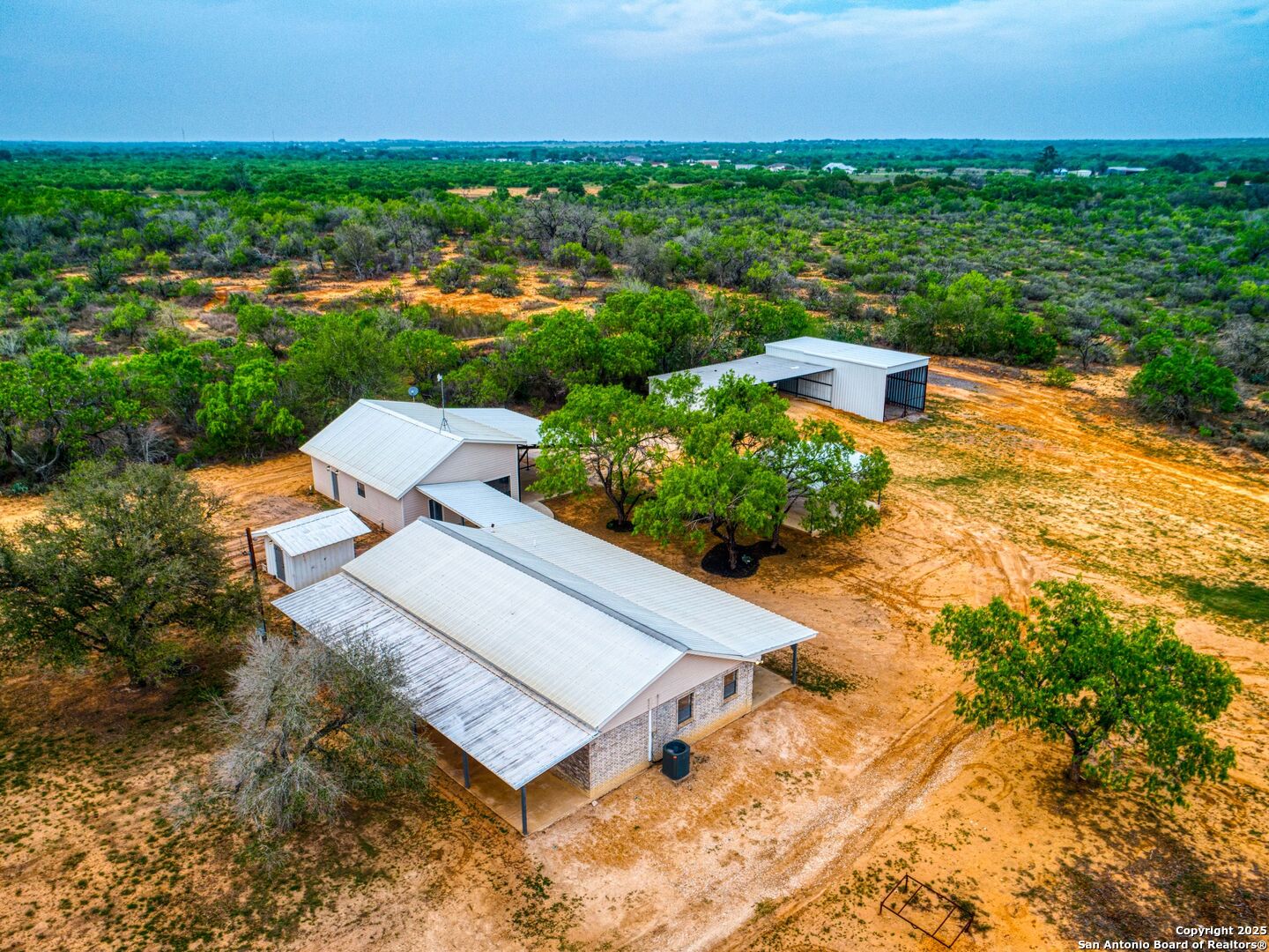 601 Wild Flower Drive Lytle, TX 78052 - Photo 47 of 50 an aerial view of a house with a garden and lake view
