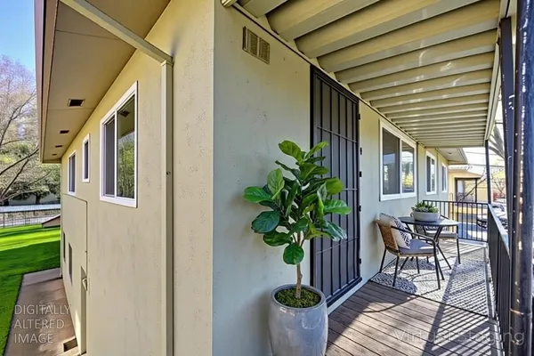 a house with potted plants in front of it