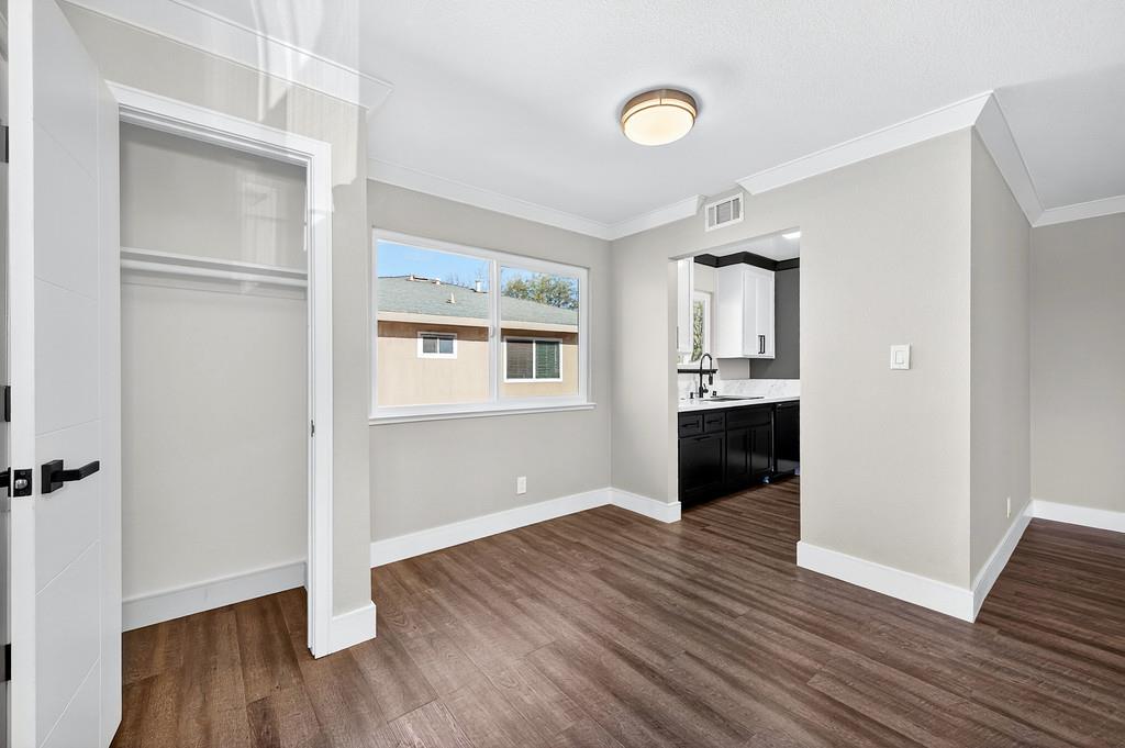 10803 Coloma Road, Unit 4 Rancho Cordova, CA 95670 - Photo 12 of 49 an empty room with wooden floor and windows