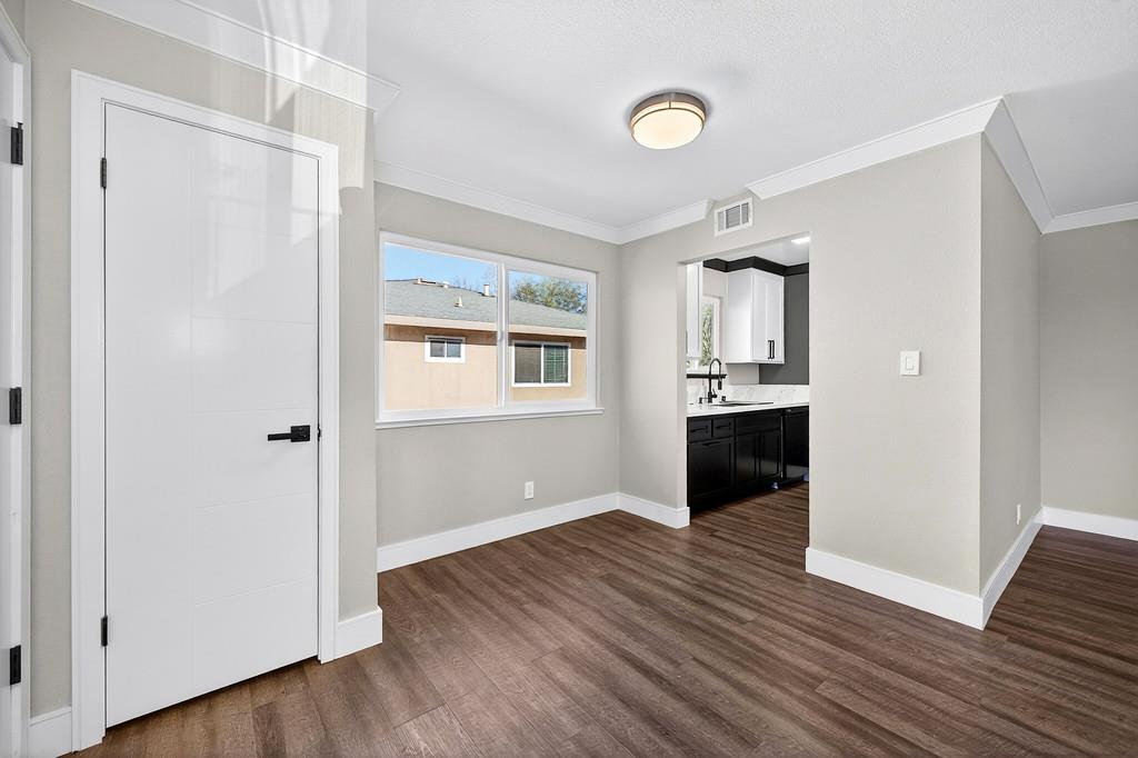 10803 Coloma Road, Unit 4 Rancho Cordova, CA 95670 - Photo 13 of 49 a view of a kitchen with wooden floor and a refrigerator