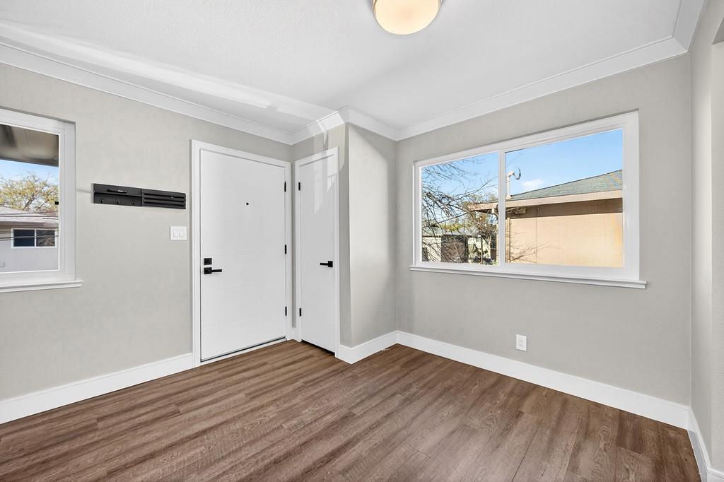 10803 Coloma Road, Unit 4 Rancho Cordova, CA 95670 - Photo 15 of 49 a view of an empty room with wooden floor and a window