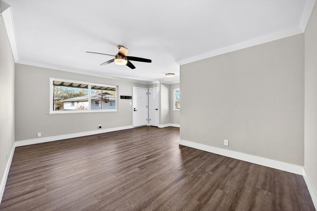 10803 Coloma Road, Unit 4 Rancho Cordova, CA 95670 - Photo 17 of 49 an empty room with wooden floor chandelier fan and windows
