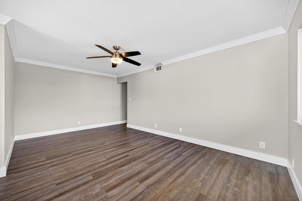 10803 Coloma Road, Unit 4 Rancho Cordova, CA 95670 - Photo 21 of 49 an empty room with wooden floor and ceiling fan