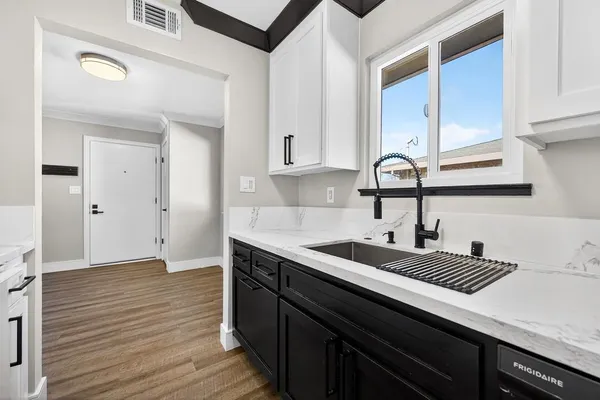 an empty room with window and ceiling fan