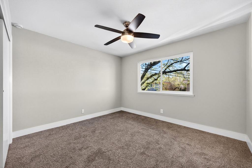 10803 Coloma Road, Unit 4 Rancho Cordova, CA 95670 - Photo 31 of 49 an empty room with window and ceiling fan