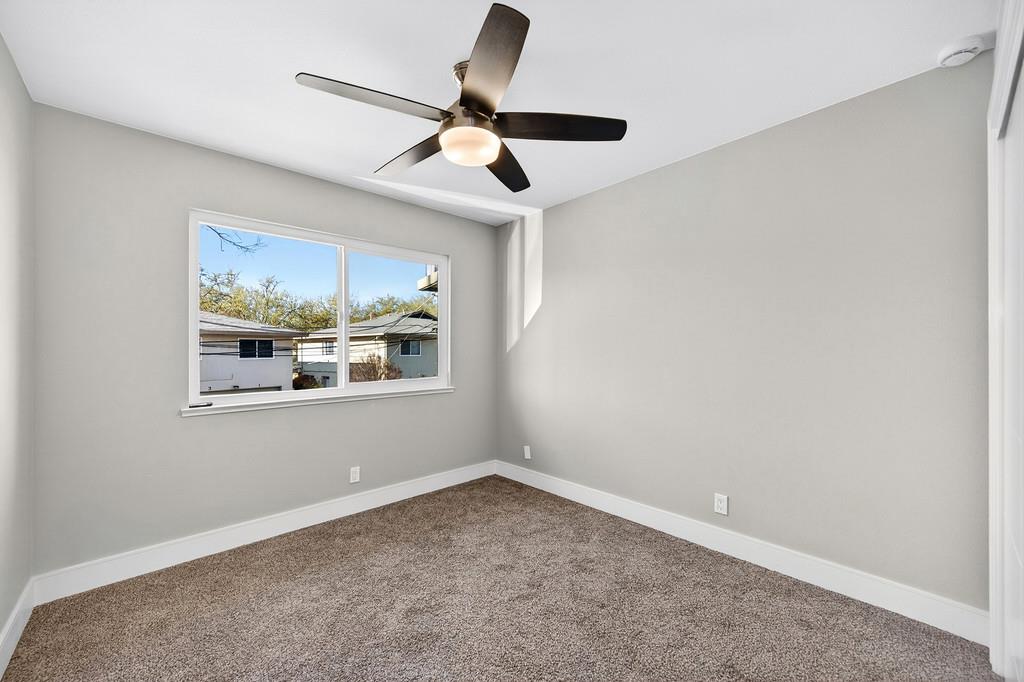 10803 Coloma Road, Unit 4 Rancho Cordova, CA 95670 - Photo 32 of 49 an empty room with window and ceiling fan