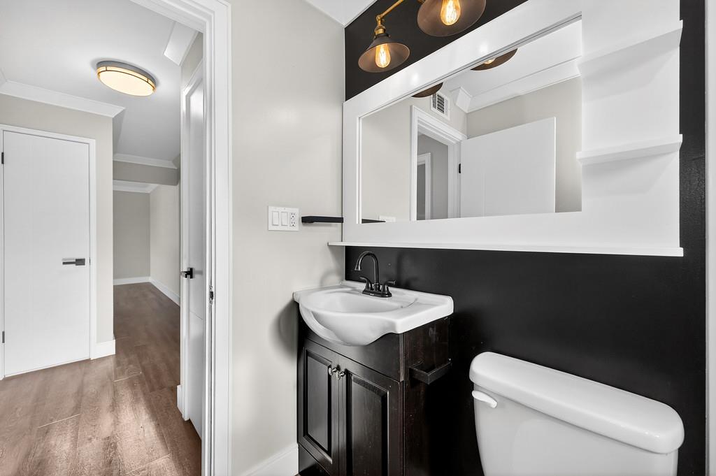 10803 Coloma Road, Unit 4 Rancho Cordova, CA 95670 - Photo 36 of 49 a bathroom with a toilet sink and mirror