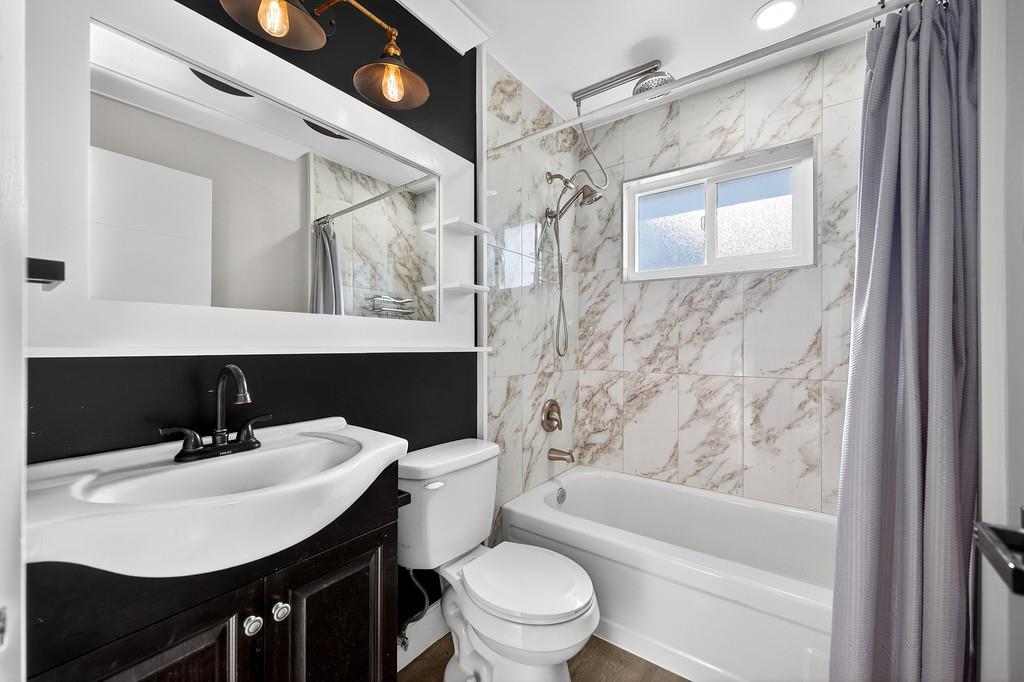 10803 Coloma Road, Unit 4 Rancho Cordova, CA 95670 - Photo 37 of 49 a bathroom with a sink toilet a mirror and shower