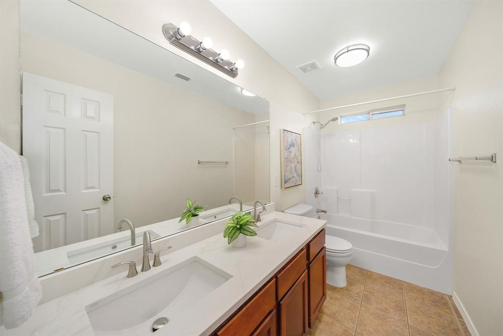 2400 Rushing Springs Drive Fort Worth, TX 76118 - Photo 29 of 40 a bathroom with a tub sink and mirror