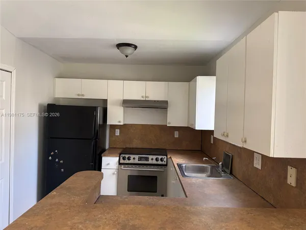 a kitchen with a stove and a refrigerator