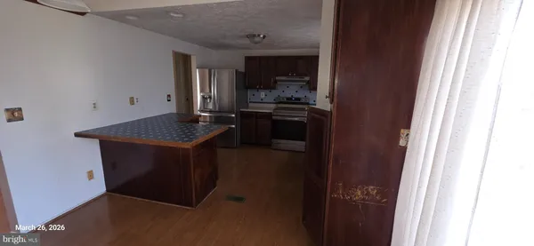 a kitchen with a refrigerator and a stove