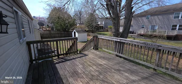 a view of a roof deck with wooden floor and fence