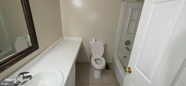 a white toilet sitting next to a sink and toilet