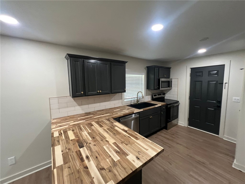 4501 College Main Street, Unit 1 Bryan, TX 77801 - Photo 3 of 8 a large kitchen with a refrigerator and a stove top oven