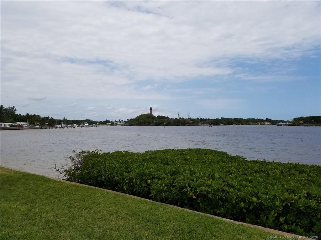 755 Saturn Street, Unit F205 Jupiter, FL 33477 - Photo 1 of 19 a view of a lake from a yard and lake view