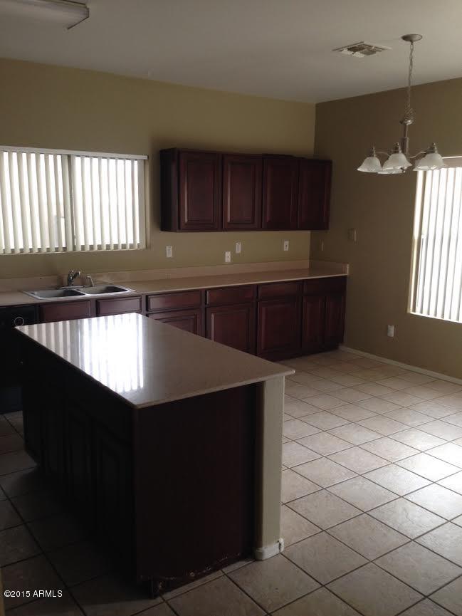 3514 South Conestoga Road Apache Junction, AZ 85119 - Photo 5 of 27 a kitchen with a sink and cabinets