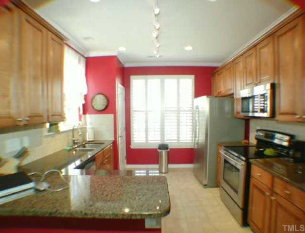 5934 Hourglass Court Raleigh, NC 27612 - Photo 3 of 10 The kitchen is open and has nice track lighting, tile floor, stainless steel appliances, double sink, granite counters and lots of storage in the large pantry. Other