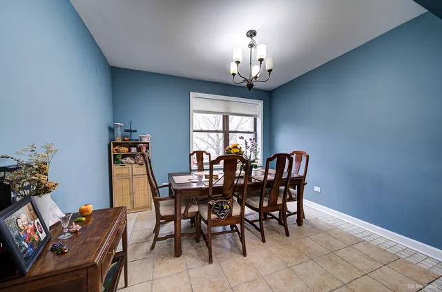 a view of a dining room with furniture and chandelier