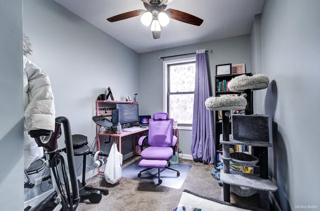 a view of a workspace with furniture and a window