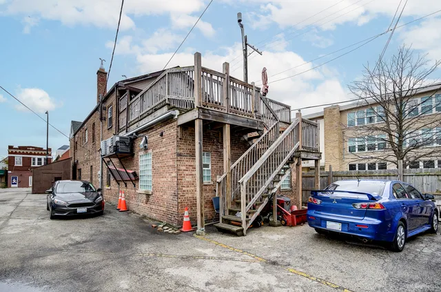 a view of a house with a small space and a wooden deck