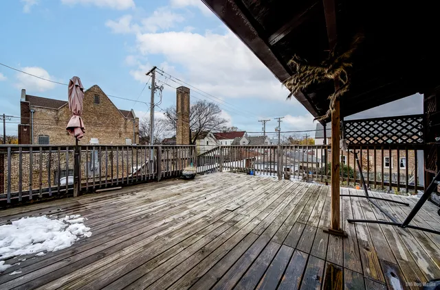 a view of a balcony with wooden floor