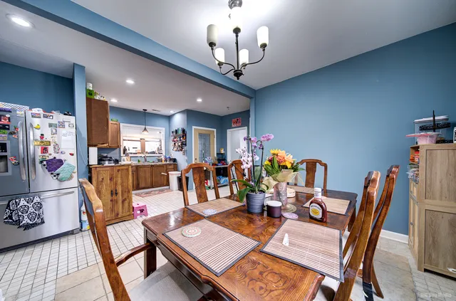 a dining room with furniture a rug and wooden floor