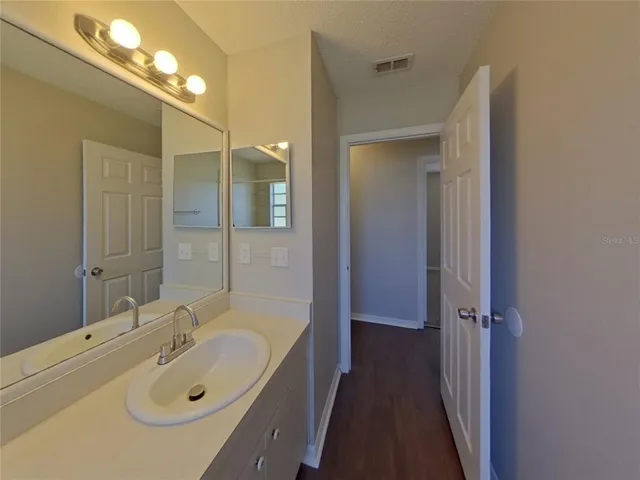 a bathroom with a sink and mirror