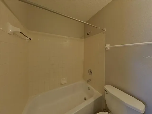 a bathroom with a toilet and a bathtub