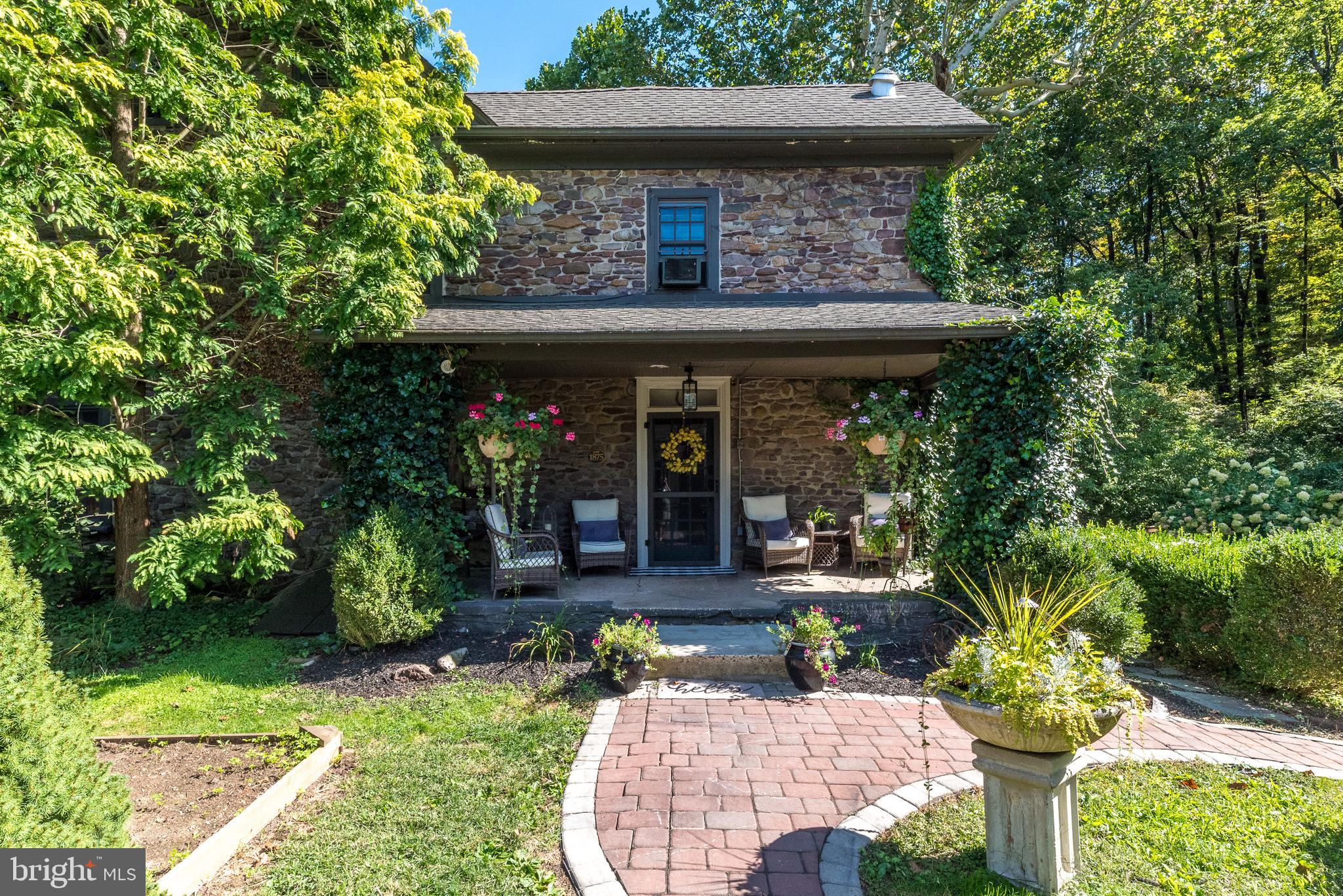 a view of a chair and table in backyard of the house