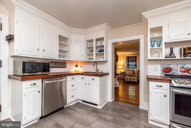 a kitchen with stainless steel appliances granite countertop a stove and cabinets