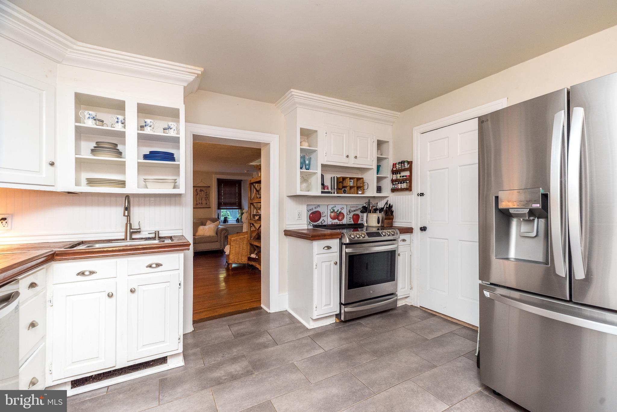 9022 Easton Road Ottsville, PA 18942 - Photo 13 of 45 a kitchen with stainless steel appliances granite countertop a refrigerator stove and a sink