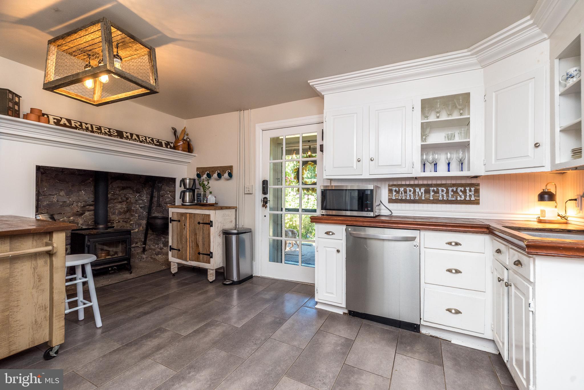 9022 Easton Road Ottsville, PA 18942 - Photo 14 of 45 a kitchen that has a lot of cabinets in it and wooden floors