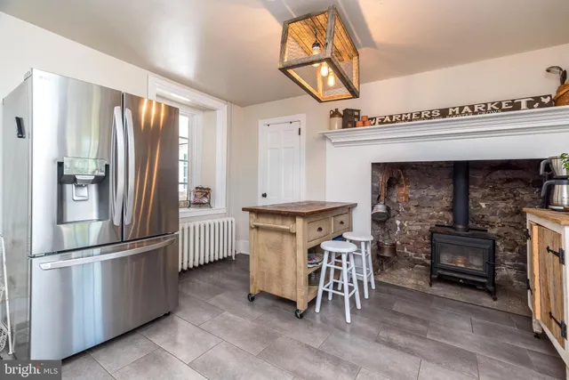 a kitchen with refrigerator and cabinets