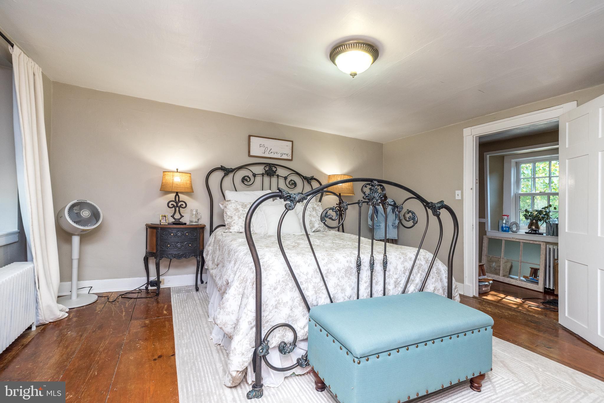 9022 Easton Road Ottsville, PA 18942 - Photo 20 of 45 a living room with a bed and a chandelier