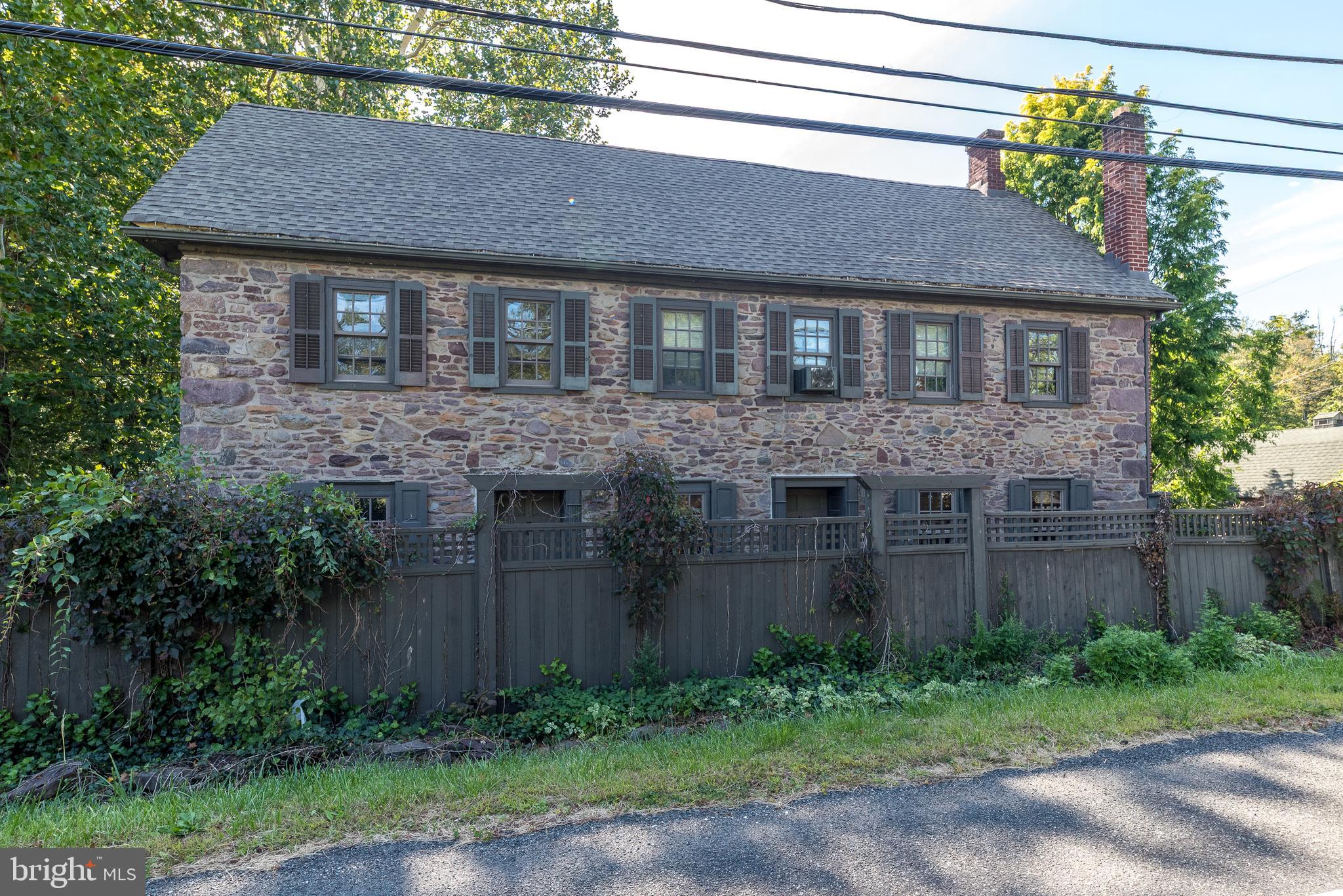 9022 Easton Road Ottsville, PA 18942 - Photo 2 of 45 a brick house with a yard plants and large tree