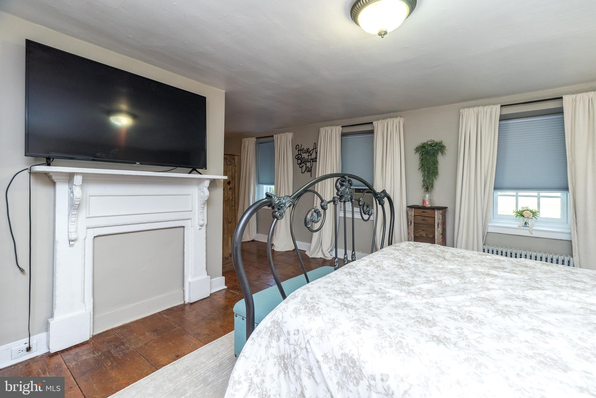 9022 Easton Road Ottsville, PA 18942 - Photo 21 of 45 a bedroom with a bed and a flat screen tv