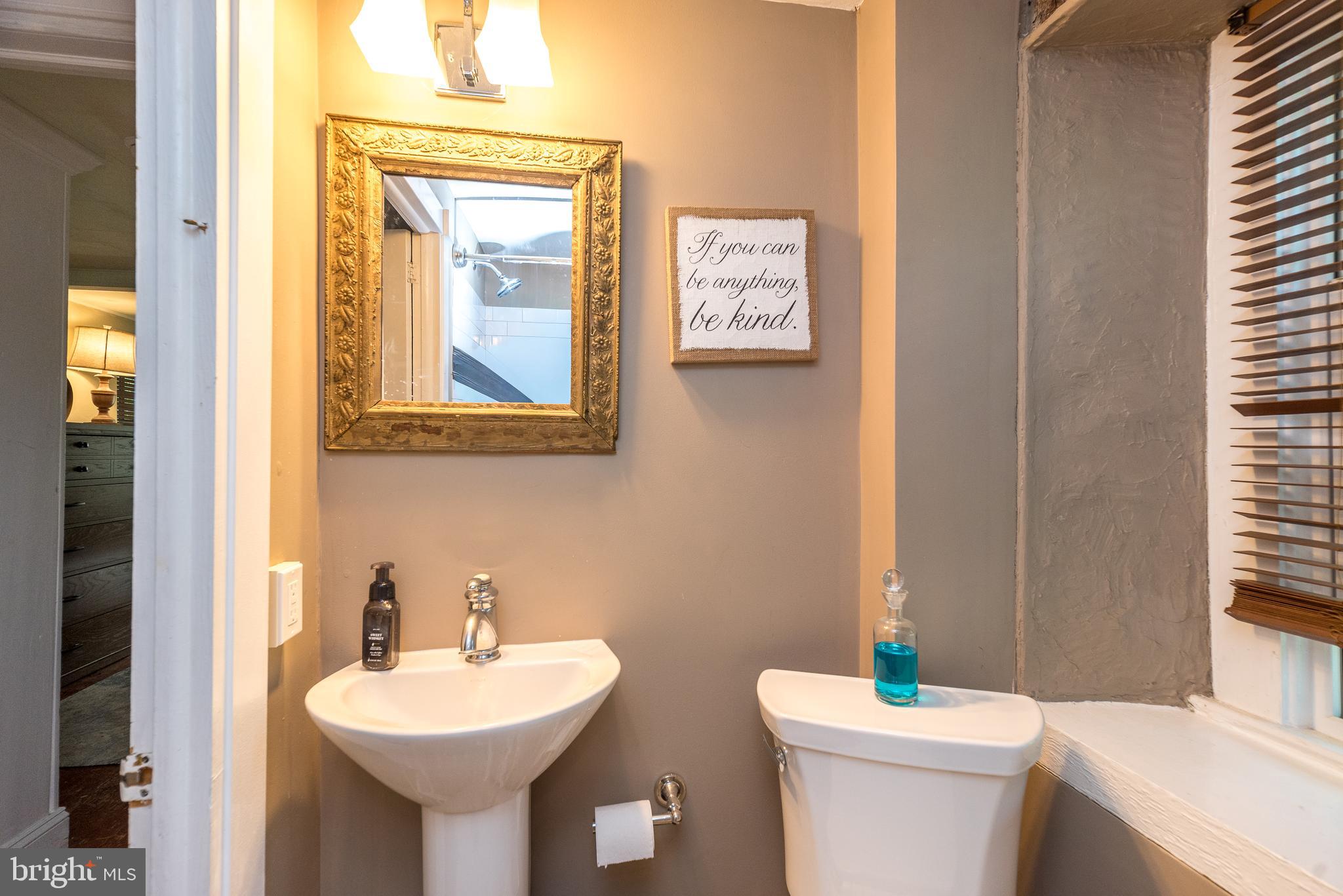 9022 Easton Road Ottsville, PA 18942 - Photo 23 of 45 a bathroom with a toilet sink and mirror