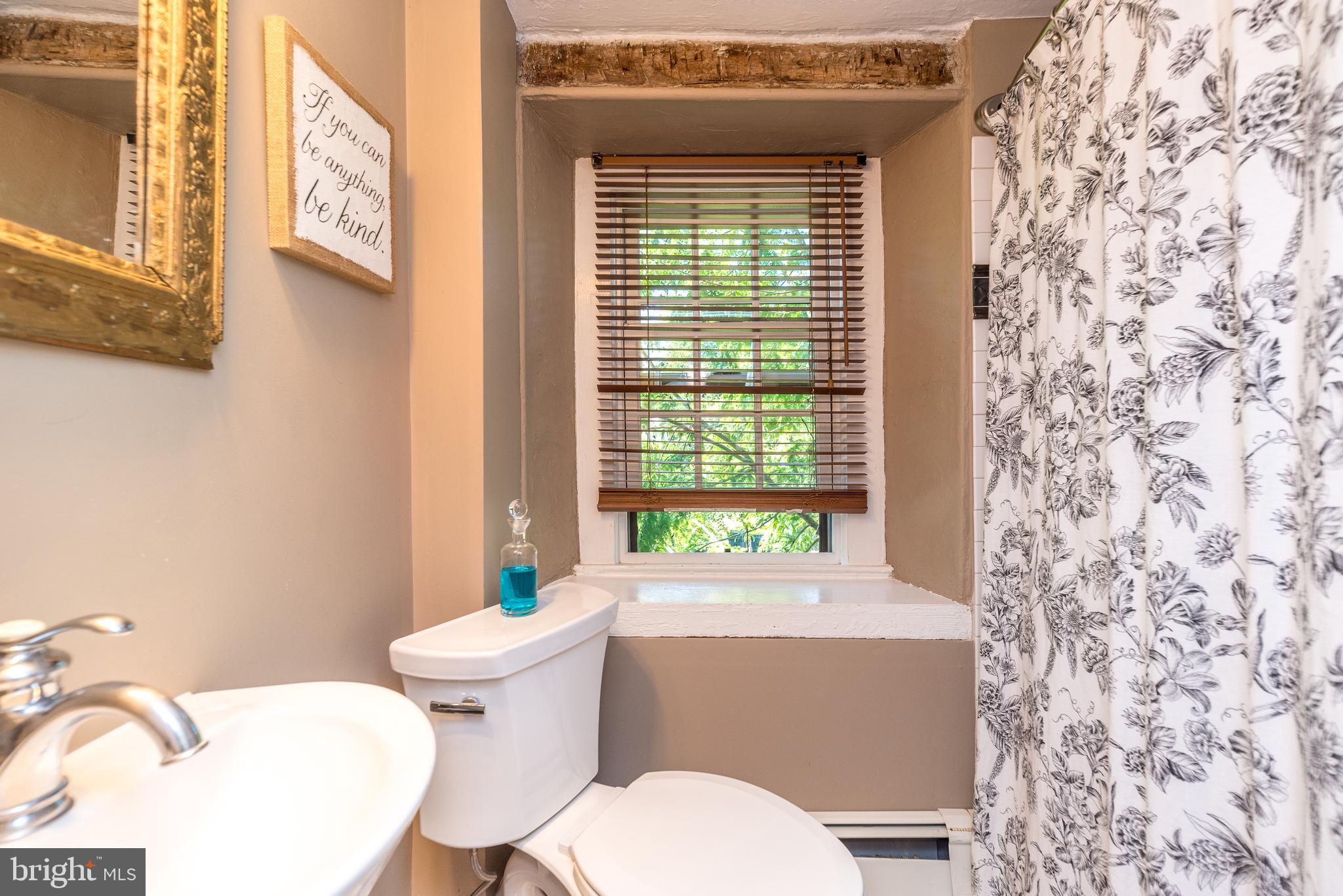 9022 Easton Road Ottsville, PA 18942 - Photo 24 of 45 a bathroom with a toilet sink and mirror