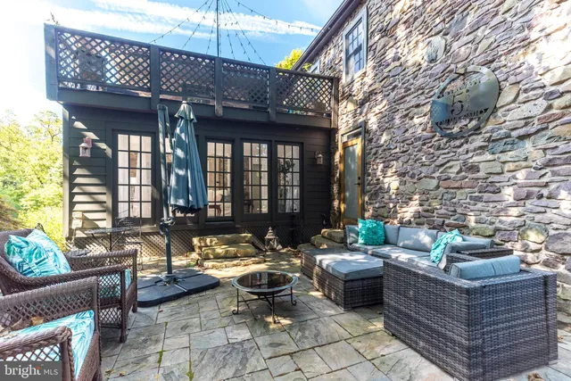 a outdoor living space with furniture and a fireplace