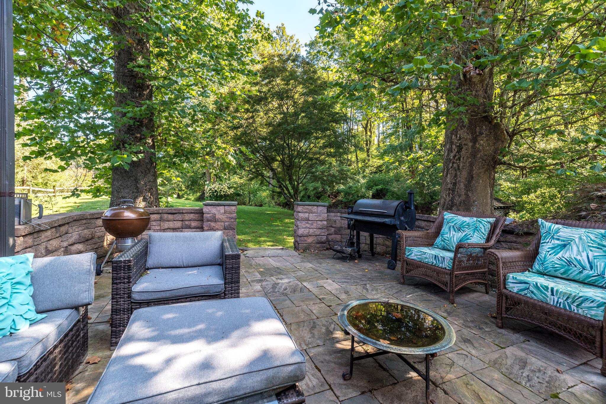 9022 Easton Road Ottsville, PA 18942 - Photo 28 of 45 a backyard of a house with fire pit and outdoor seating