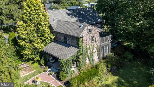 an aerial view of a house with a yard