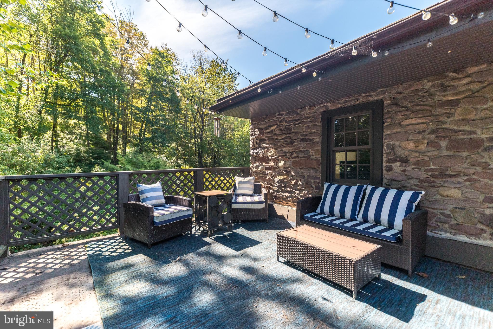 9022 Easton Road Ottsville, PA 18942 - Photo 43 of 45 a roof deck with a couch and wooden fence