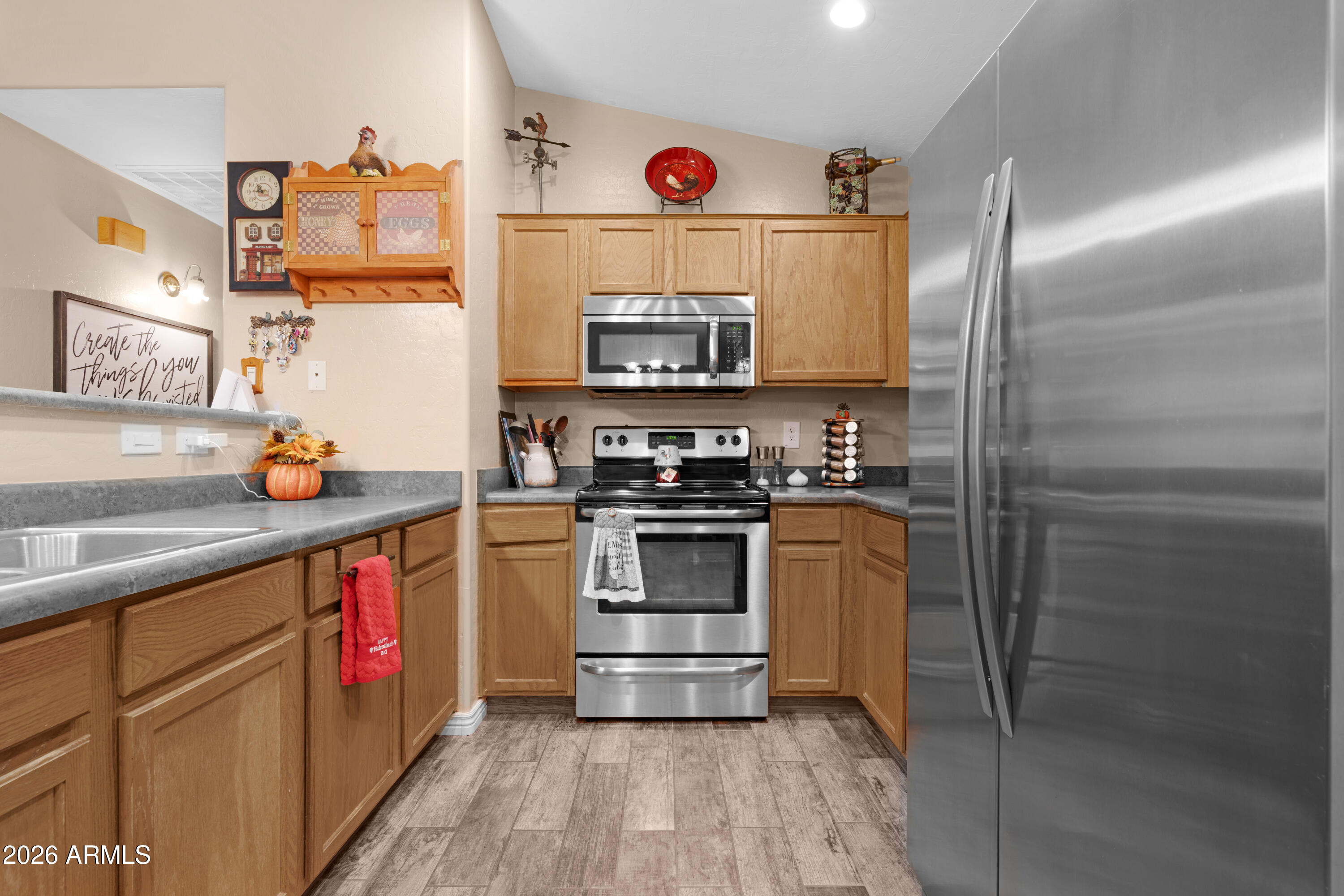 12018 West Almeria Road Avondale, AZ 85392 - Photo 10 of 39 a kitchen with stainless steel appliances granite countertop a refrigerator and a stove top oven