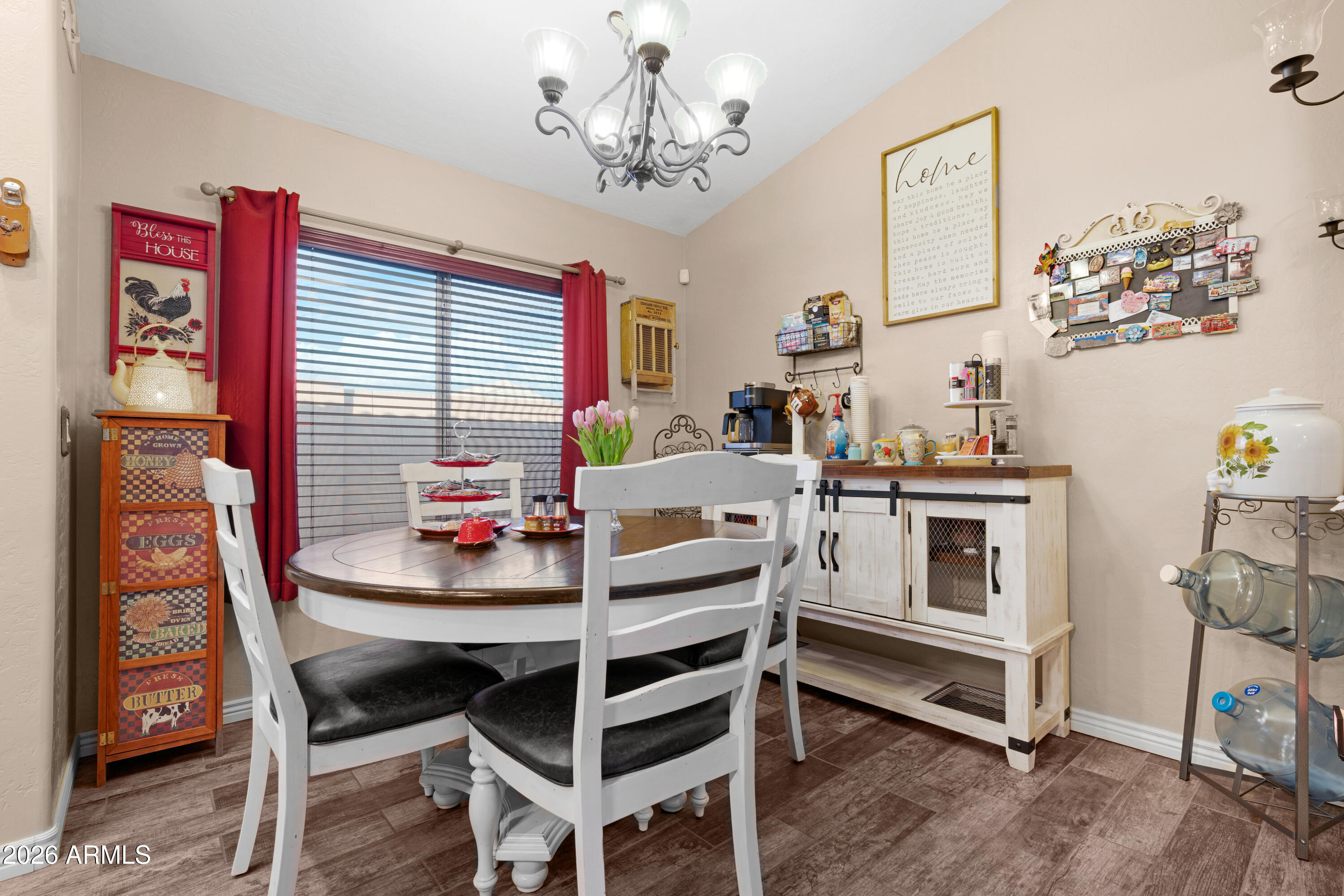 12018 West Almeria Road Avondale, AZ 85392 - Photo 12 of 39 a view of a dining room with furniture and chandelier