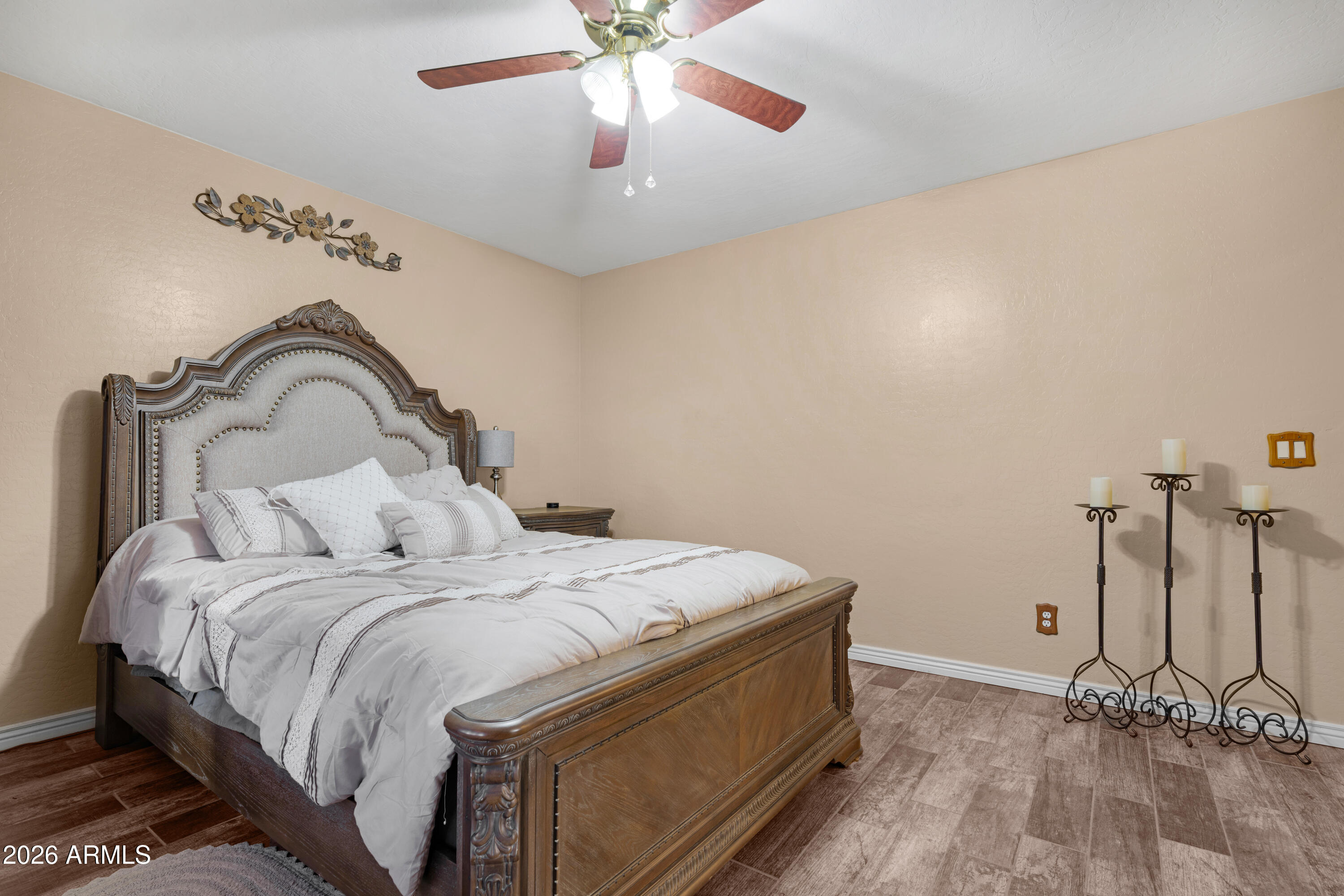 12018 West Almeria Road Avondale, AZ 85392 - Photo 14 of 39 a bedroom with a bed and a chandelier