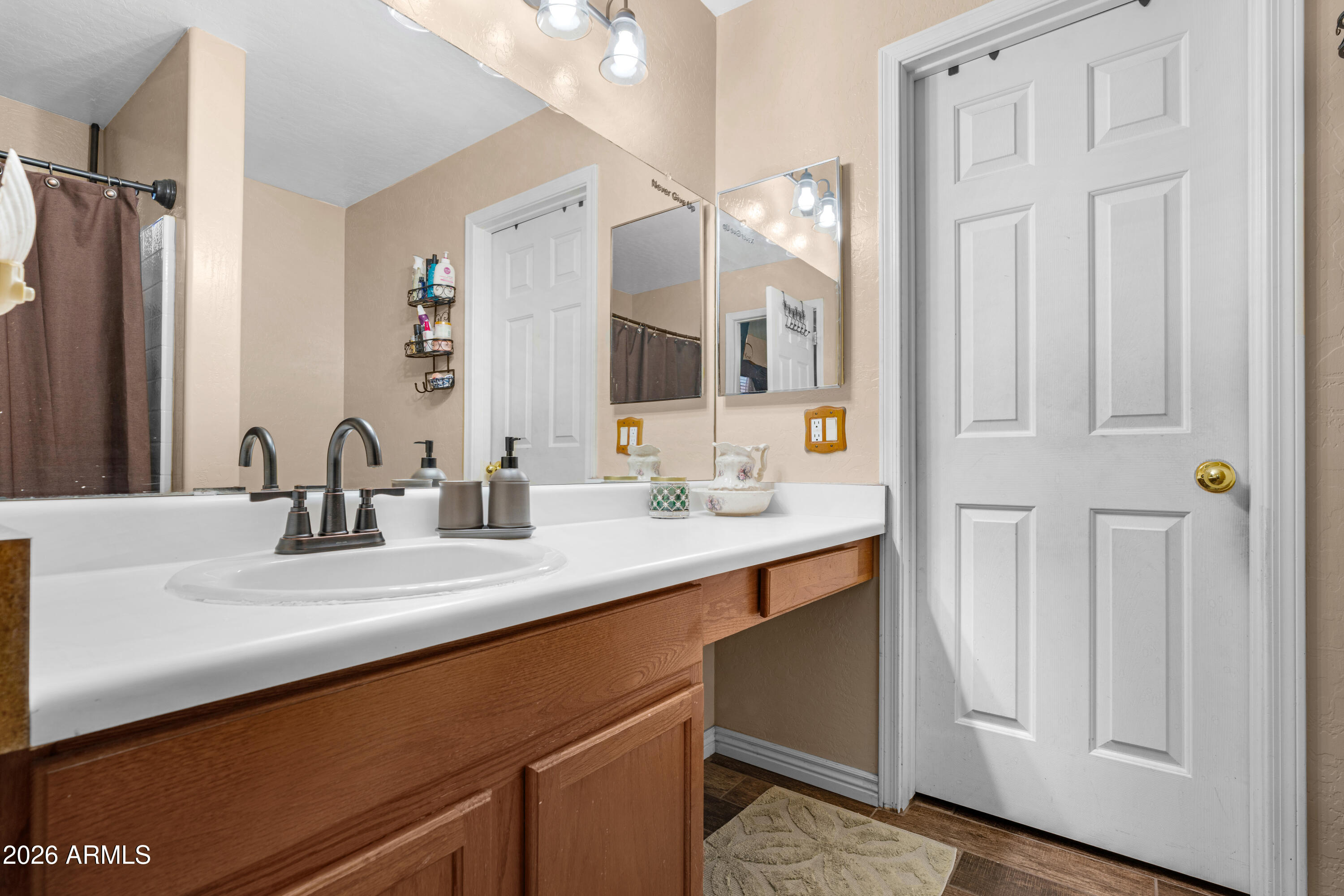 12018 West Almeria Road Avondale, AZ 85392 - Photo 16 of 39 a bathroom with a double vanity sink and a mirror