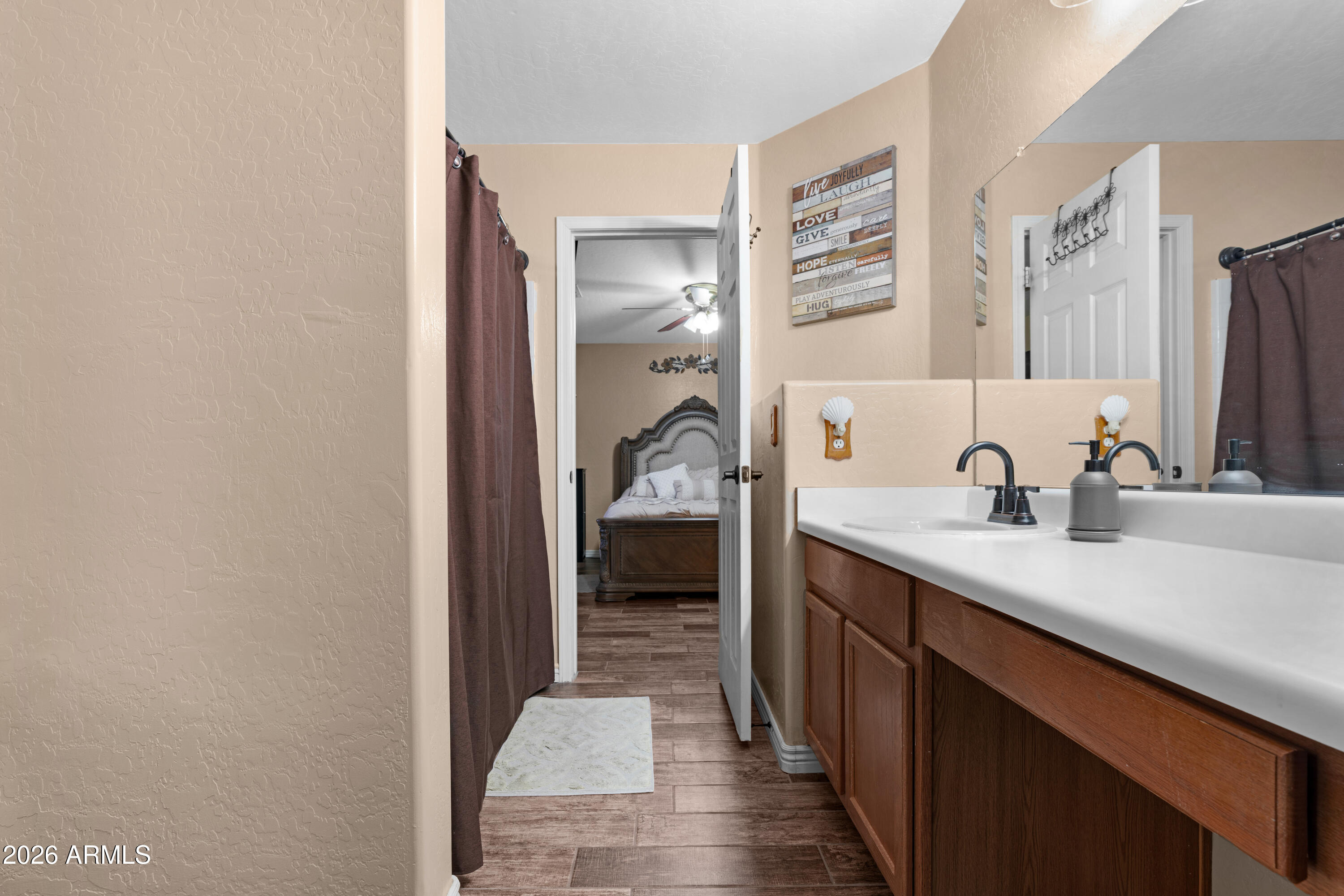12018 West Almeria Road Avondale, AZ 85392 - Photo 17 of 39 a en suite bathroom with a sink and a mirror