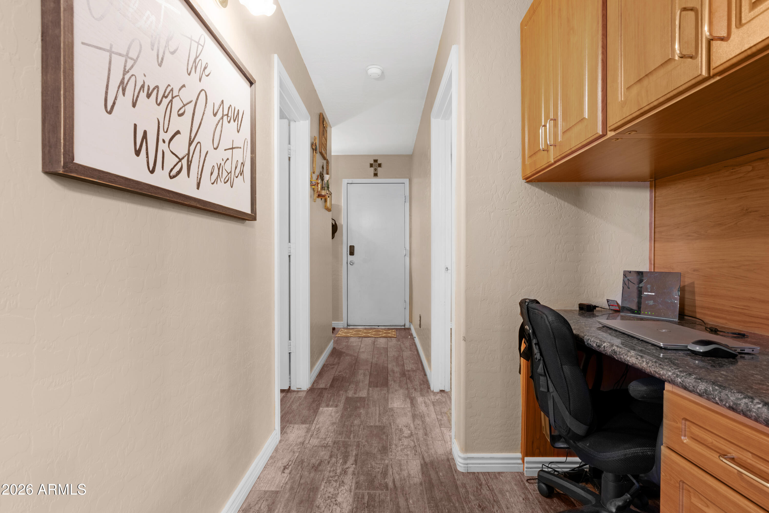 12018 West Almeria Road Avondale, AZ 85392 - Photo 19 of 39 a view of a hallway with workspace